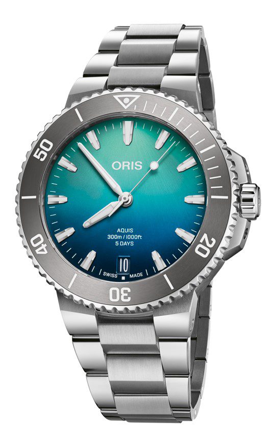 The Oris Aquis - Great Barrier Reef Limited Edition is a sleek stainless steel wristwatch featuring a round dial that transitions from green to blue. The dial includes luminous hands and markers, along with a date window positioned at 6 o'clock. Additionally, the bezel is marked with numerals at regular intervals, and the watch comes equipped with a metal link band.