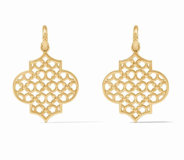 The Julie Vos Helene Statement Hoop & Charm Earrings are a pair of intricate gold hoops featuring a quatrefoil design and a delicate floral pattern at their center. Elegant hooks at the top add to their ornate and sophisticated appearance.