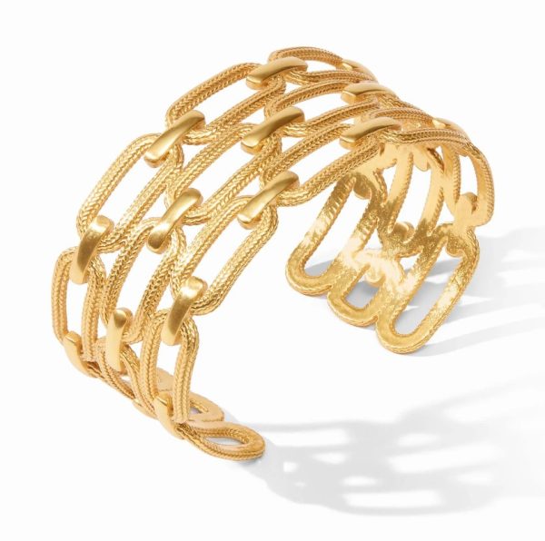 The Julie Vos Cheval Paperclip Cuff is a gold cuff bracelet with an open design featuring multiple interwoven, curved strands that form a linked chain pattern. The bracelet exudes a modern and elegant look, casting a slight shadow on the white background.