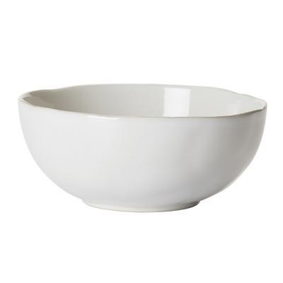 The Juliska Puro Cereal Bowl - Whitewash is a pristine, white ceramic bowl featuring a smooth, glossy finish. Its gently curved shape and slightly irregular rim lend it a handcrafted touch. Positioned against a plain, white background, the bowl appears both elegant and unique.