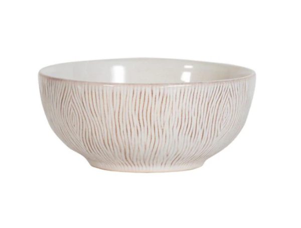 The Juliska Blenheim Oak Cereal/Ice Cream Bowl in Whitewash is a white ceramic bowl featuring subtle reddish-brown vertical lines that create a textured pattern on its exterior. This bowl boasts a smooth, glossy finish and exudes simple, elegant design.