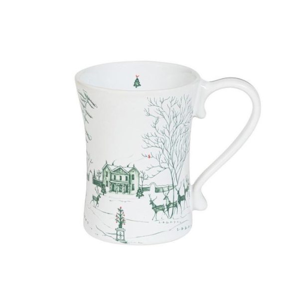 The Juliska Country Estate Winter Frolic Mug - Wintergreen showcases a winter scene with a large house, several bare trees, and a group of deer. The artwork is rendered in green on a white background, encircling the mug. Inside the lip of the mug, there is a charming small Christmas tree design.