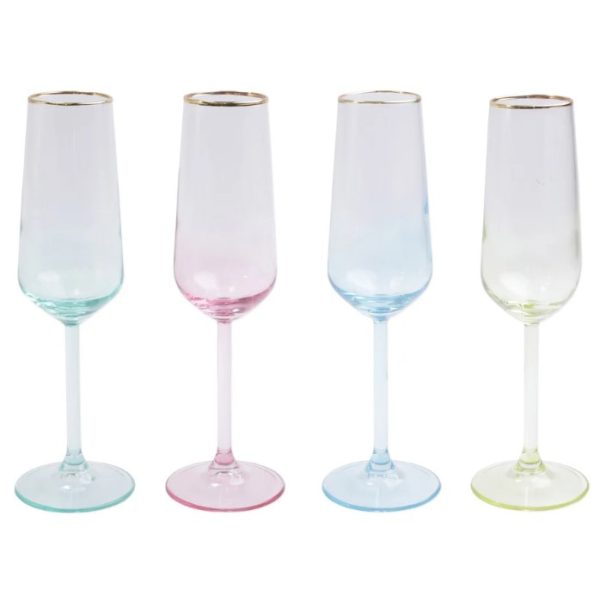 The Vietri Rainbow Assorted Champagne Flutes - Set of 4 are displayed in a row, featuring tall, slender designs. Each flute boasts a thin gold rim and a colored base that extends slightly up the stem: one with a green base, one pink, one blue, and one yellow. Their design is simple and elegant.