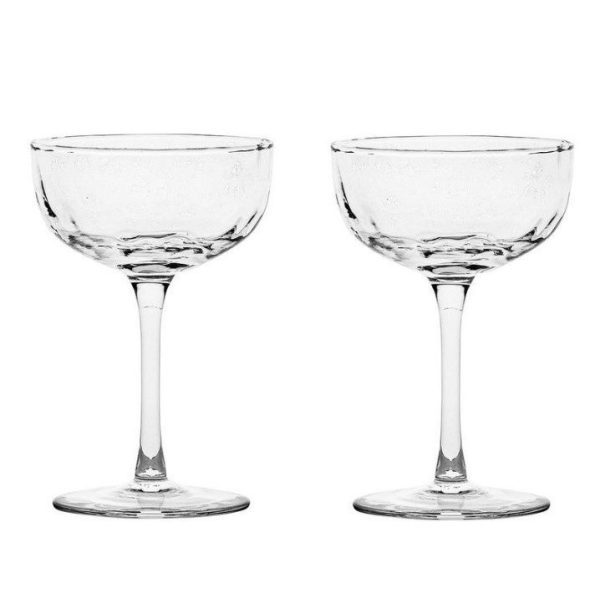 Two Juliska Puro Cocktail Coupe glasses with wide, shallow bowls and thin stems are displayed side by side against a plain, white background.