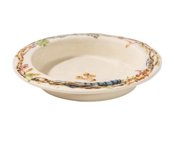 The Juliska Forest Walk Pie Dish is a decorative ceramic plate with a shallow depth, adorned with a nature-inspired design along the rim that includes leaves, pinecones, acorns, and branches. This primarily cream-colored plate features an intricate and colorful border.