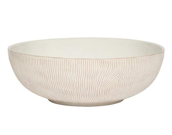 The Juliska Blenheim Oak 12" Serving Bowl features a white ceramic exterior adorned with subtle, light brown vertical line patterns that mimic the texture of wood grain. This wide, round bowl has a smooth, slightly curved lip and sits on a slightly raised base.