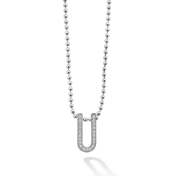 The LAGOS Caviar Spark Large Linear Diamond Pendant Necklace boasts a silver chain of small, round beads and features a pendant shaped like a capital "U". The pendant is embellished with sparkling diamonds, offering a luxurious and elegant appearance. The necklace's shadow is cast on the white background.