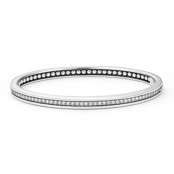 Introducing the LAGOS Caviar Spark Diamond Bangle Bracelet: a sleek, minimalist bangle that showcases a row of small, evenly spaced diamonds set in a thin silver band. Its circular design exudes elegance and sophistication, further highlighted against a plain white background.