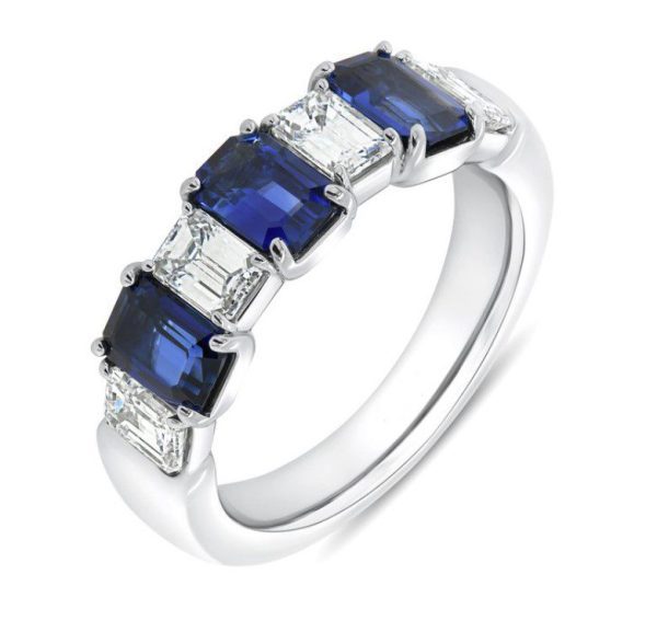 The Bromberg's Signature Collection Sapphire and Diamond Band features a sleek, modern design with alternating rectangular blue sapphires and clear diamonds. Each stone is securely held in place by prongs on a polished silver band, creating an elegant and contemporary look.