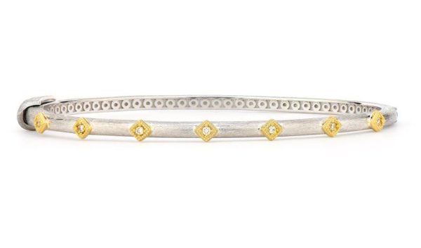 The JudeFrances Mixed Metal Diamond Kite Bangle is a sleek silver bracelet adorned with evenly spaced, diamond-shaped gold accents. Each gold accent holds a small, sparkling diamond at its center, creating a striking contrast against the simple silver band. The clasp is visible on the left side.