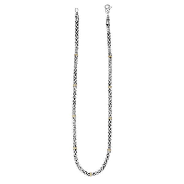 The LAGOS Signature Caviar Two-Tone Caviar Beaded Necklace features intricate silver link designs with gold accents at regular intervals, secured with lobster clasps at both ends for a secure closure. This elegantly designed chain seamlessly combines sophistication with modern style.