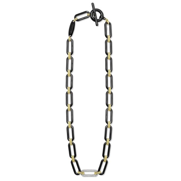 The LAGOS Signature Caviar 18K Gold and Black Ceramic Diamond Station Link Necklace features a geometric design with alternating black ceramic and gold segments, creating a monochromatic and modern appearance. The necklace is arranged in a loop and includes an oversized toggle clasp, adding an elegant touch to its sophisticated style.