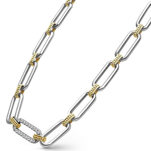 The LAGOS Signature Caviar Two-Tone Link Single Station Diamond Necklace showcases a stylish design with alternating large silver links and smaller gold links. One of the silver links near the bottom is adorned with embedded white diamonds, adding an elegant touch to this modern and chic piece.