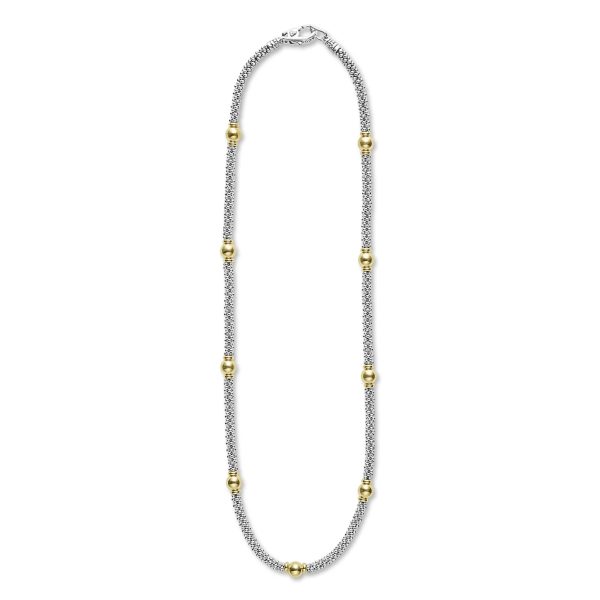 Image of the LAGOS Signature Caviar 18K Gold Station Necklace, showcasing a silver chain adorned with multiple evenly spaced gold beads. This necklace features a lobster clasp closure and textured design on the silver chain links. The combination of silver and gold presents a striking two-tone aesthetic.