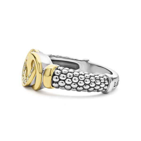 The LAGOS Signature Caviar Two-Tone Interlocking Diamond Ring showcases a beautiful combination of silver and gold elements. The band features a beaded silver texture with a smooth gold and silver knot design, accentuated by small diamonds on one side, while the inside of the band remains plain and smooth.