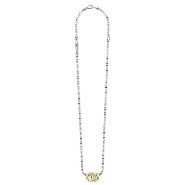 The LAGOS Signature Caviar Two-Tone Interlocking Diamond Pendant Necklace features a long, silver chain with small, round links. At its heart lies an ornate, gold-toned letter "C" adorned with intricate detailing. The clasp and connecting elements are small and silver, seamlessly complementing the chain's elegant design.