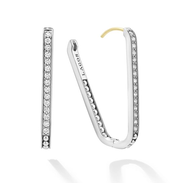 A pair of LAGOS Caviar Spark Large Linear Diamond Hoop Earrings are shown. Each earring is adorned with a line of small, sparkling diamonds along the front. One earring is displayed in its entirety, while the other is positioned to show its open side and curved gold hook.