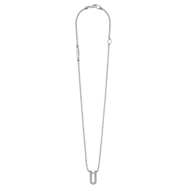 Introducing the **LAGOS Caviar Spark Small Linear Diamond Pendant Necklace**: a silver necklace featuring a delicate thin chain and a U-shaped pendant adorned with small, sparkling diamonds. The chain is elegantly secured with a lobster clasp and includes a small tag near the clasp, which also features a tiny diamond. This design exudes an air of delicacy and minimalist sophistication.