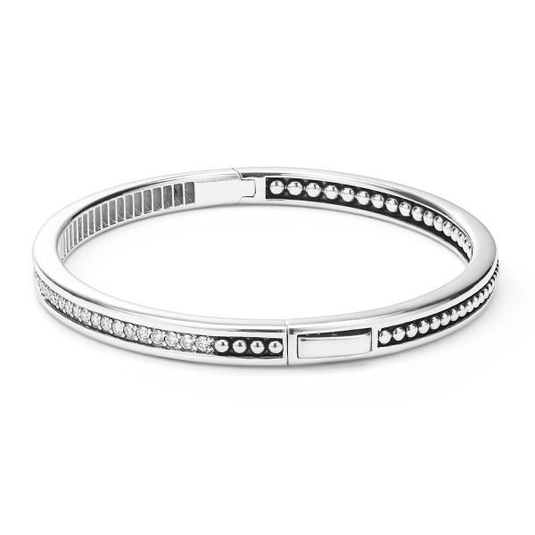 The LAGOS Caviar Spark Diamond Bangle Bracelet is a sleek silver accessory featuring a detailed design with alternating rows of small silver beads and sparkling stones set against a dark background. It boasts a smooth, polished finish and a secure clasp.