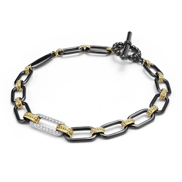 The LAGOS Signature Caviar Bracelet showcases interlocking black ceramic links accented with 18K gold details, and features one link encrusted with small white diamonds. This stunning bracelet is fastened with a toggle clasp, adding a touch of elegance to its design.