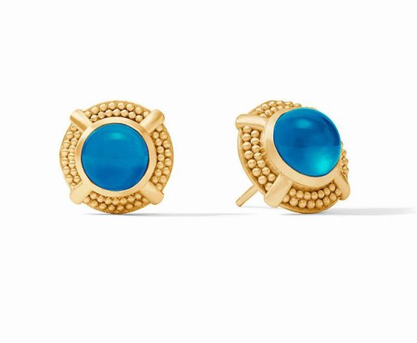 The Julie Vos Cabochon Stud Earrings - Iridescent London Blue feature a blue, round cabochon stone in the center. These stones are set within a textured gold frame adorned with delicate beaded details.