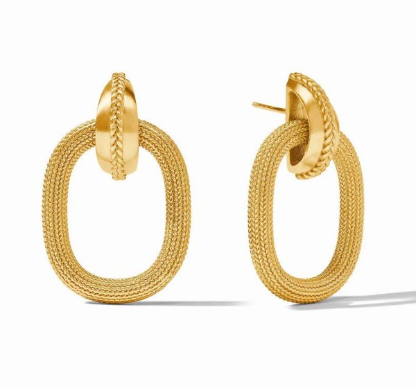 Introducing the Julie Vos Cheval Doorknocker Earrings: an elegant pair of gold hoop earrings featuring a distinctive woven texture. These oval-shaped loops are connected with a smaller, solid, and subtly twisted gold piece that securely attaches to the earlobe, exuding a modern and sophisticated charm.