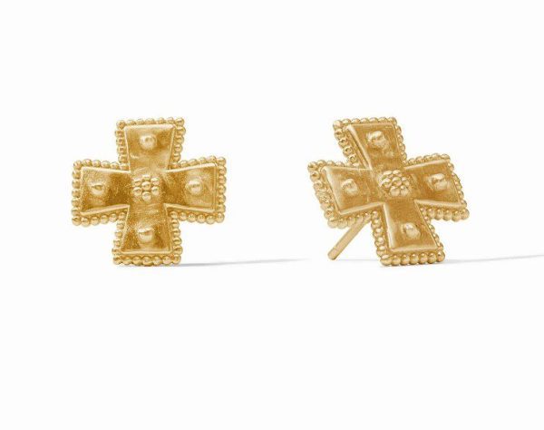 Introducing the Julie Vos Canterbury Stud Earrings: a pair of gold cross-shaped earrings featuring a textured, beaded pattern. These earrings come with stud back fittings. In this image, one earring rests flat while the other is positioned at an angle, casting a subtle shadow against a white background.