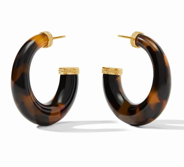 The Julie Vos Large Madison Statement Hoop Earrings in Tortoise Shell feature a chic tortoiseshell pattern with rich dark brown and amber tones, set in elegant gold-tone hardware. Designed with a thick band, the earrings boast intricate gold detailing where the hoop connects to the earlobe, making for a stylish and modern accessory.