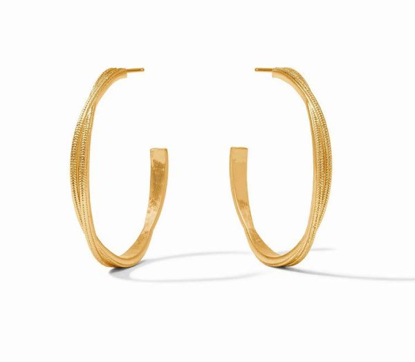 A pair of Julie Vos Medium Cheval Twist Hoop Earrings is laid on a white background. Each hoop, in a medium size with a gold finish, features a textured, twisted rope pattern that exudes sophistication and elegance. The earrings cast soft shadows, highlighting their three-dimensional shape.