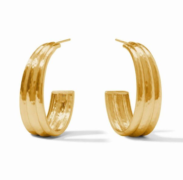 A pair of Julie Vos Cirque Hoop Earrings - Large in gold, featuring a thick, ridged design with a closed back and a subtle reflective shine, positioned upright against a white background.