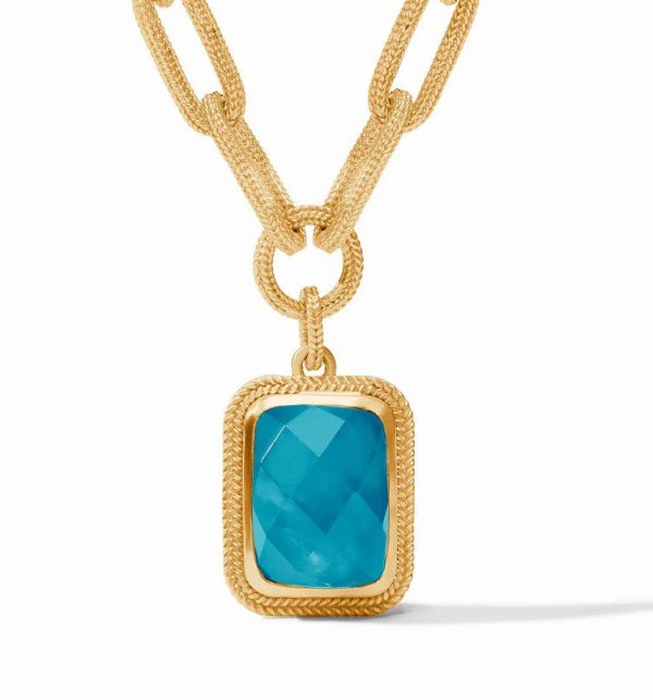 The Julie Vos Cheval Paperclip Statement Necklace - Iridescent London Blue features a gold chain with a textured double-linked design. The rectangular pendant showcases a faceted iridescent London blue gemstone set in a textured gold frame, hanging from a large loop.