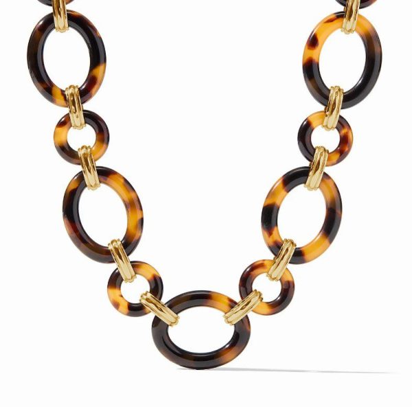 The Julie Vos Madison Link Necklace showcases large, round tortoiseshell rings connected by gold-toned links. The rings display a mix of brown and amber hues with a glossy finish, creating a sophisticated and stylish accessory.