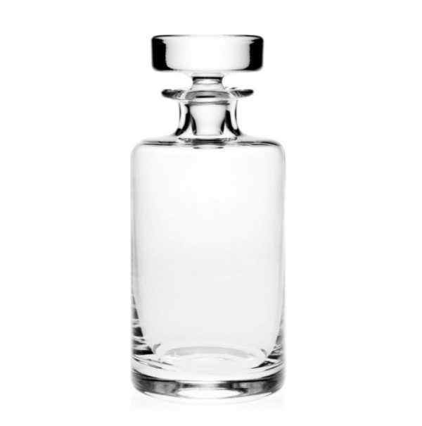 The William Yeoward Lillian Spirit Decanter features a clear glass body with a cylindrical shape and a smooth, sleek design. It includes a round, flat-topped stopper and is empty, presented against a plain white background.