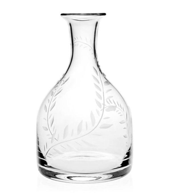 The William Yeoward Jasmine Magnum Carafe is a clear glass decanter with a wide base and narrow neck, featuring an etched leafy vine design that wraps around its surface.