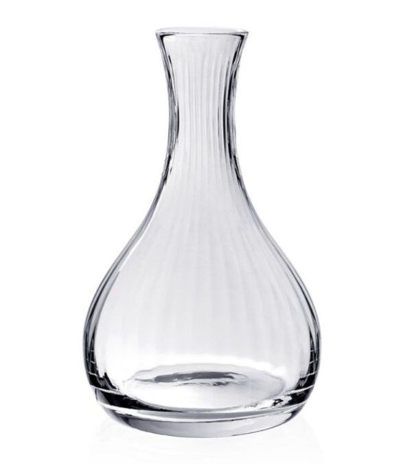 The William Yeoward Corinne Wine Carafe features a clear glass design with a wide, round base and a narrow neck. Subtle vertical ridges run from the base to the neck, providing it with a slightly textured appearance against a plain white background.