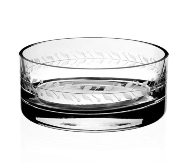 A clear glass William Yeoward Ada Bottle Stand with a cylindrical shape, etched with a pattern of horizontal leaves around the rim. The elegant design gives it a sophisticated, decorative appearance. The bottle stand is displayed against a plain white background.