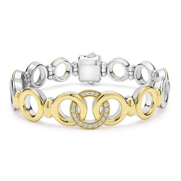 The LAGOS Signature Caviar Two-Tone Interlocking Diamond Link Bracelet showcases alternating gold and silver circular links. The centerpiece consists of three interlocking rings in gold, with the central ring adorned with small, sparkling diamonds. The clasp is meticulously designed to complement the silver links.