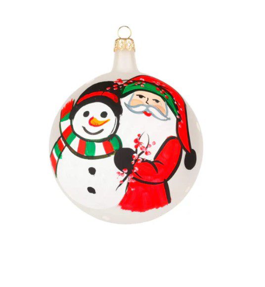 The Vietri Old St. Nick 2024 Limited Edition Ornament is a round Christmas decoration showcasing a hand-painted Santa Claus in a red suit and hat with green trim, smiling next to a snowman adorned with a red and green striped scarf and hat against a white background.