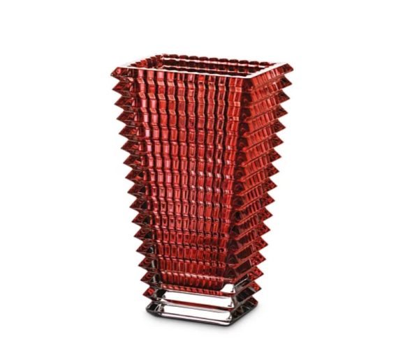 The Baccarat Rectangular Eye Vase in red is a tall glass vase featuring a square base and an intricate zigzag design.