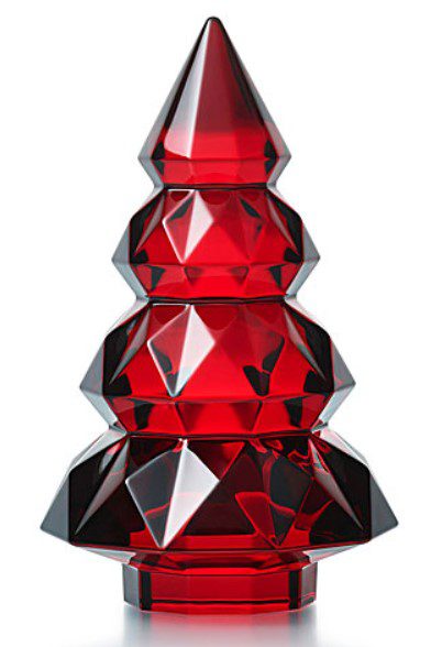 The Baccarat 2024 Louxor 5" Tree - Red is a striking red sculpture designed to resemble a stylized Christmas tree. It features multiple tiered layers with diamond-like angles, offering a geometric and modern appearance.