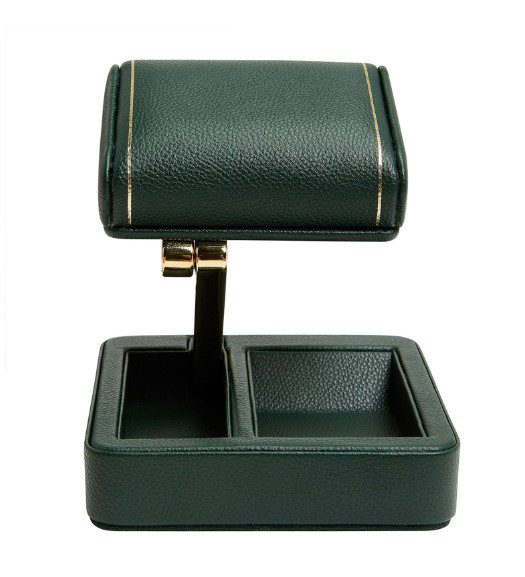 The Wolf 1834 British Racing Single Travel Watch Stand is a green leather accessory with gold accents, featuring a rotating compartment for winding and two empty storage slots at the base.