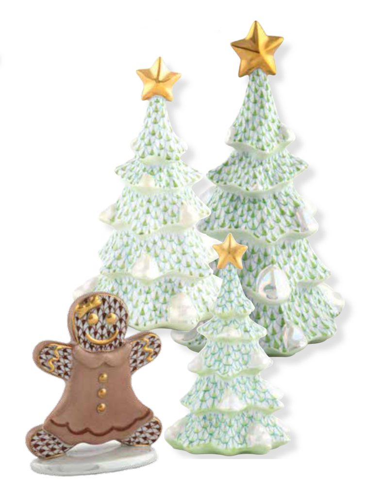 Three decorative ceramic Christmas trees with golden stars on top are accompanied by a festive gingerbread figure wearing a brown outfit with intricate icing patterns. The trees have a textured design and soft pastel colors.