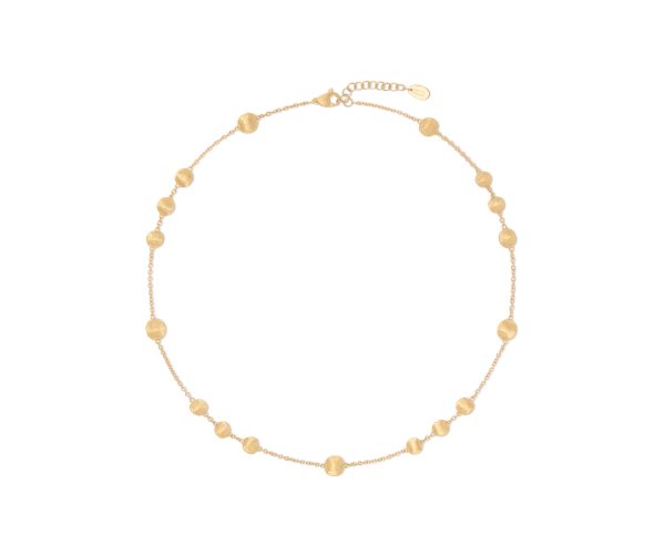 The Marco Bicego Yellow Gold Station Bead Necklace is a delicate piece featuring an adjustable chain design with round gold beads evenly spaced along it. The beads vary slightly in size, adding an elegant touch to the minimalist style.