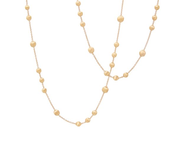 Introducing the Marco Bicego Africa Yellow Gold Station Bead Long Necklace: a finely crafted necklace featuring a delicate gold chain adorned with evenly spaced round gold beads. The chain is beautifully draped and intertwined, offering a sophisticated double-layered effect that boasts both simplicity and elegance in its design.