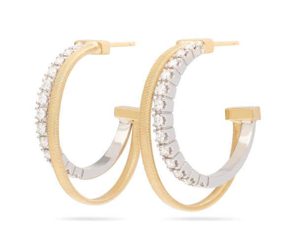 The Marco Bicego Masai Yellow Gold Double Hoop Earrings with Diamonds feature an elegant two-tone design. The outer layer boasts a ribbed yellow gold texture, while the inner side is embellished with sparkling white diamonds, all set against a plain white background.