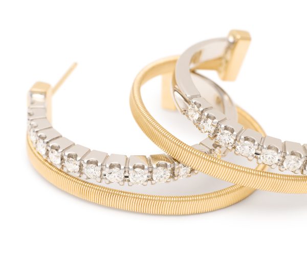 Introducing the Marco Bicego Masai Yellow Gold Double Hoop Earrings With Diamonds, these hoops showcase a stunning gold design accented with a series of dazzling clear diamonds, offering an elegant and sophisticated look.