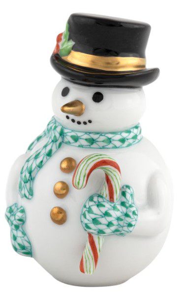 The Herend Candy Cane Snowman Figurine - Green is a ceramic piece featuring a snowman adorned with a black top hat with a gold band and holly. It wears a green scarf, holds a candy cane, and is detailed with gold buttons and a carrot-shaped nose.