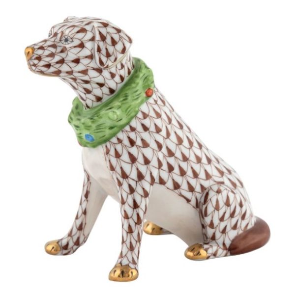 Herend Holiday Dog Figurine - Chocolate features a ceramic depiction of a seated dog adorned with a brown scale pattern and gold accents on its paws, tail, and snout. The figurine is styled with a green collar embellished with colorful jewels.