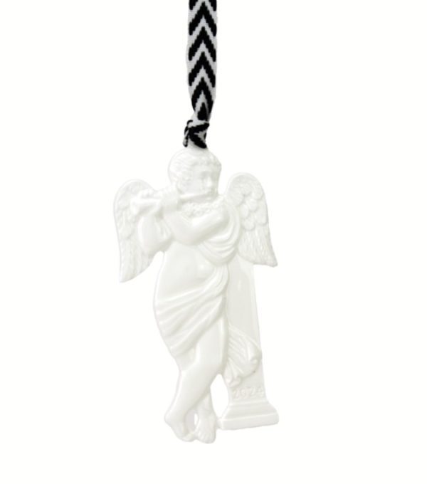 The Wedgwood 2024 Cherub Ornament - Jophiel is a white ceramic angel figurine featuring wings and a flowing garment, holding a small trumpet. It is suspended from a black and white zigzag-patterned ribbon.