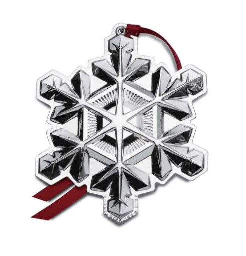 Introducing the Gorham 2024 Snowflake Ornament, a dazzling silver decoration featuring intricate geometric patterns and accompanied by a red ribbon for easy hanging.